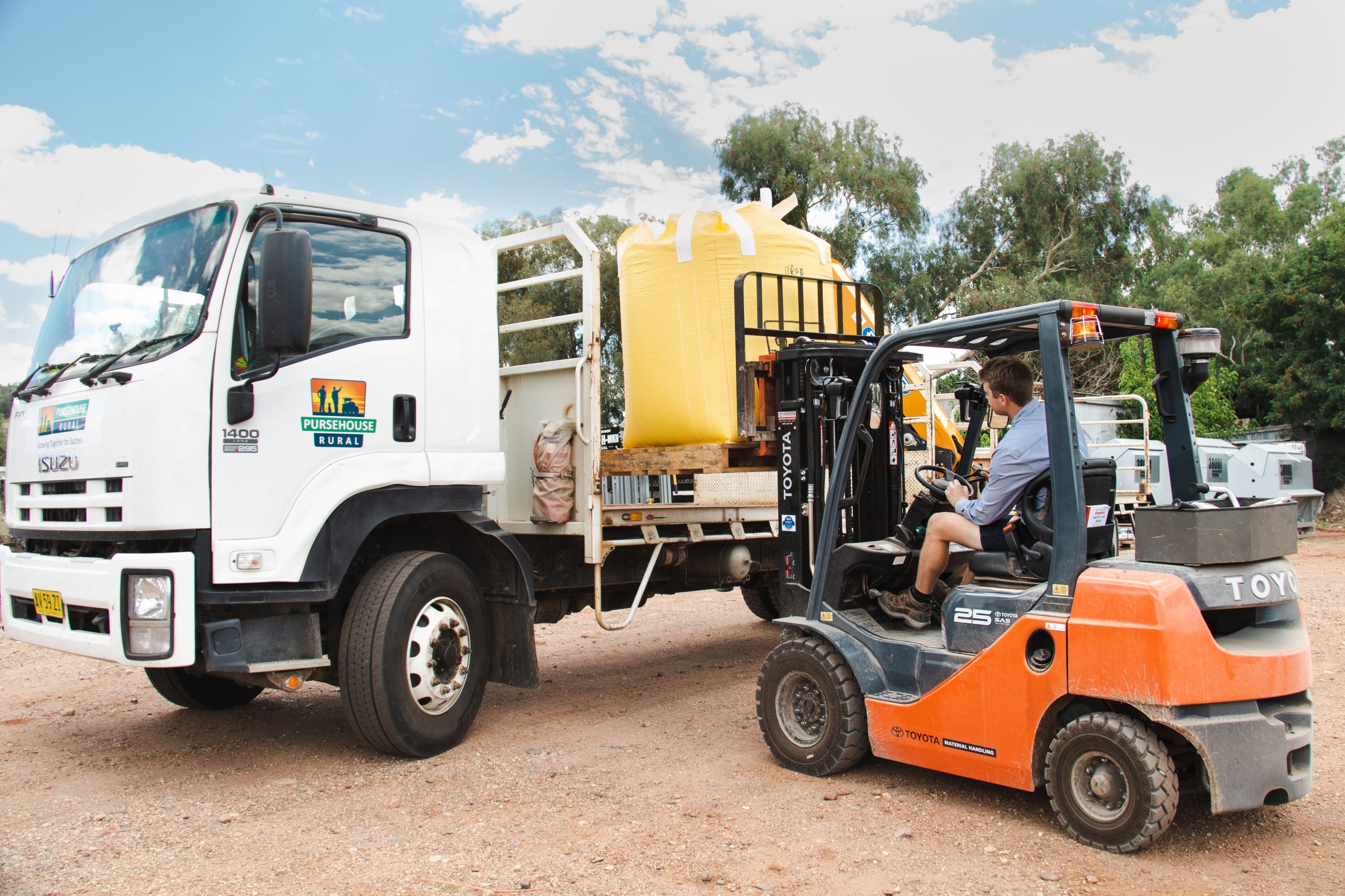 Pursehouse Rural employee lifting fertiliser onto Pursehouse Rural delivery truck with forklift